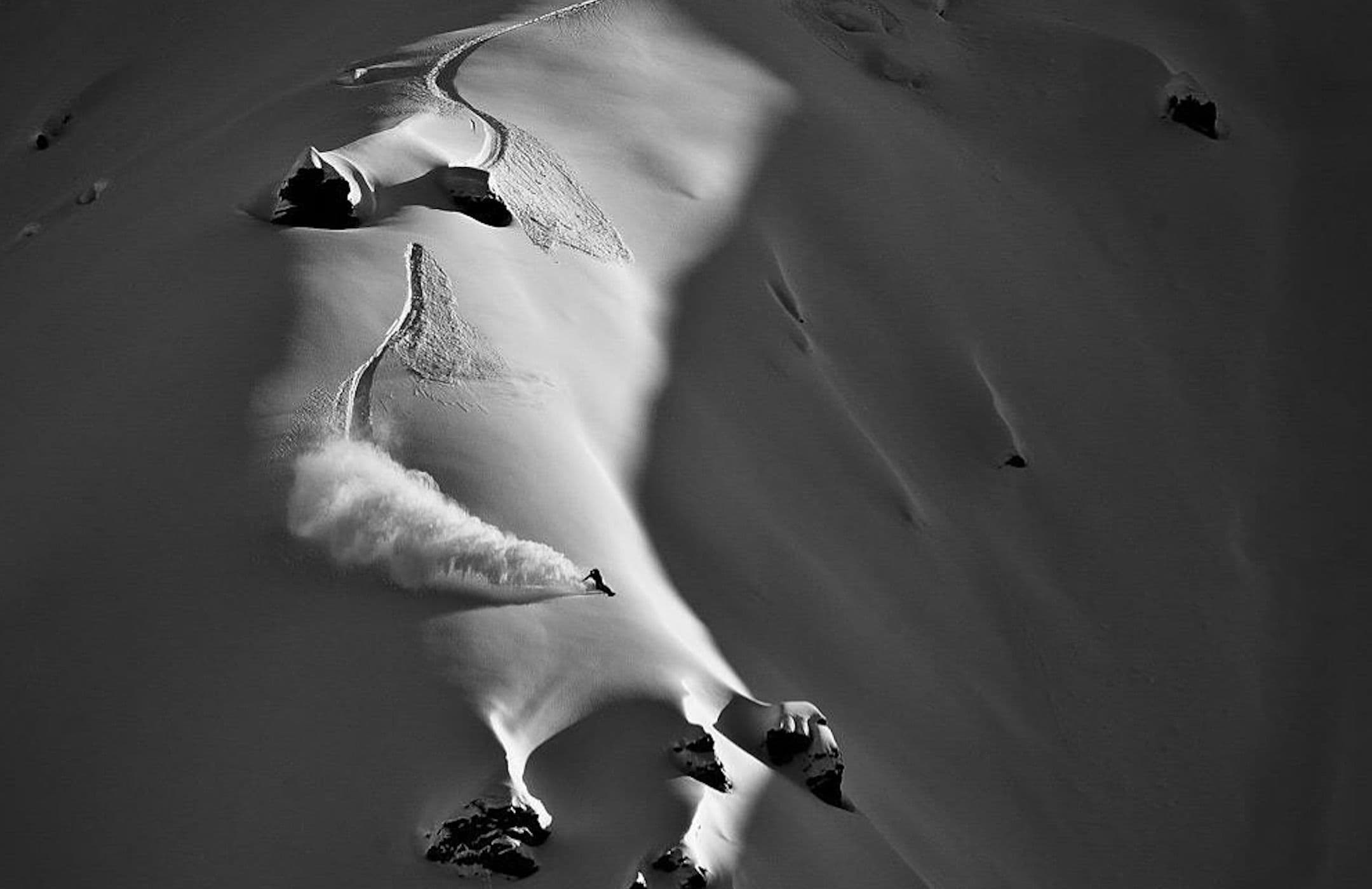 Une trace de snowboard au milieu des reliefs enneigés